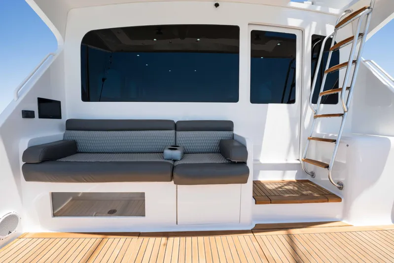 Santana Yacht Photos Pics 2003 Viking 65 Convertible yacht with cushioned seating and wooden deck.