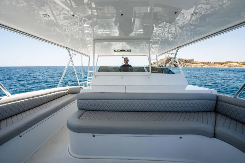 Santana Yacht Photos Pics 2003 Viking 65 Convertible yacht with spacious seating, cruising on open water.