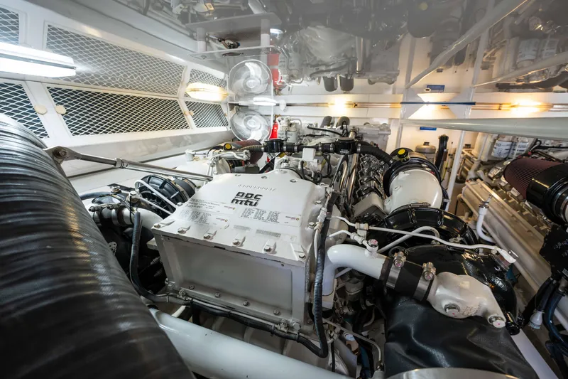 Santana Yacht Photos Pics Engine room of 2003 Viking 65 Convertible yacht, showcasing powerful machinery and components.