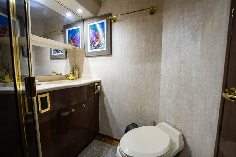 Santana Yacht Photos Pics Luxurious bathroom in a 2003 Viking 65 Convertible yacht with elegant fixtures and artwork.