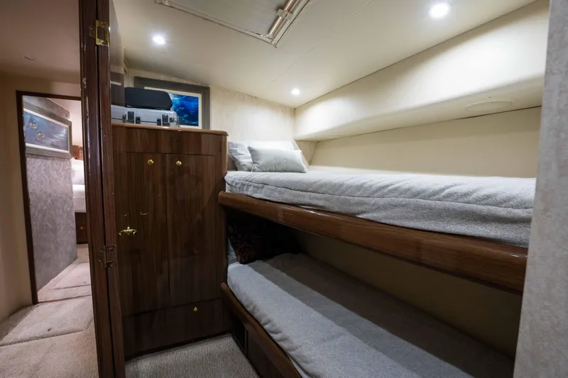 Santana Yacht Photos Pics 2003 Viking 65 Convertible yacht cabin with bunk beds and wooden cabinetry.