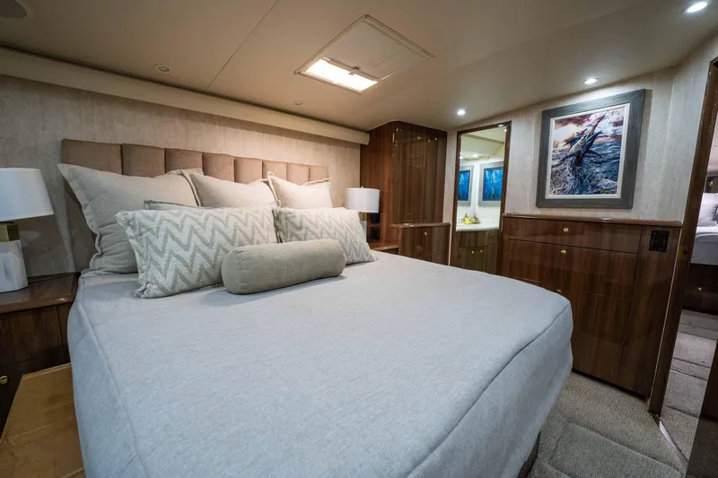 Santana Yacht Photos Pics Luxurious bedroom interior of 2003 Viking 65 Convertible yacht with elegant decor and cozy bedding.