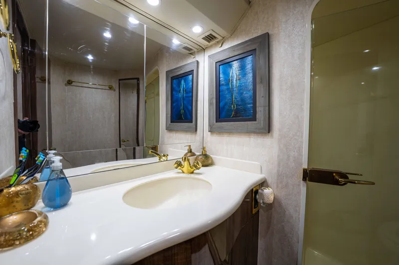 Santana Yacht Photos Pics Luxurious bathroom in 2003 Viking 65 Convertible yacht with elegant fixtures and artwork.