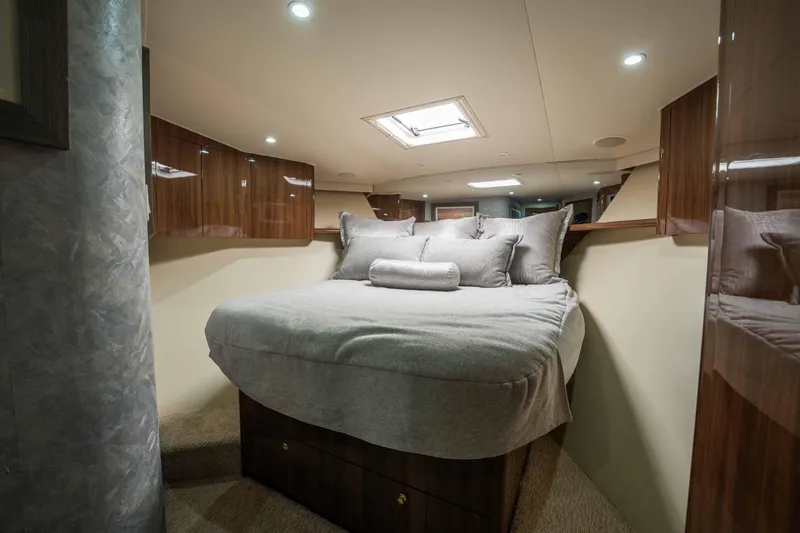Santana Yacht Photos Pics Luxurious bedroom interior of 2003 Viking 65 Convertible yacht with cozy bedding.