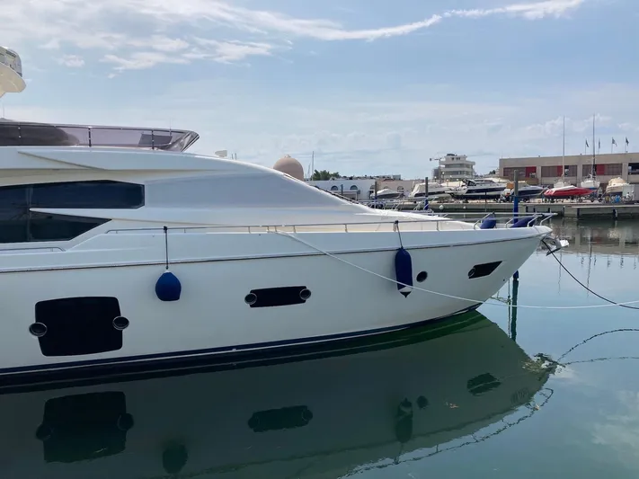4771 Yacht Photos Pics 2013 Ferretti Yachts 720 docked in a marina, reflecting on calm water.