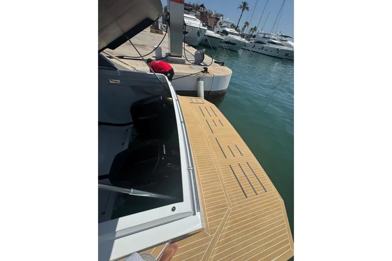  Yacht Photos Pics 2025 De Antonio Yachts D50 docked, showcasing sleek design and modern outboard engines.