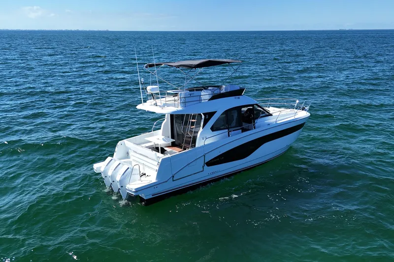  Yacht Photos Pics 2026 Beneteau Antares 12 yacht cruising on open sea under clear blue sky.