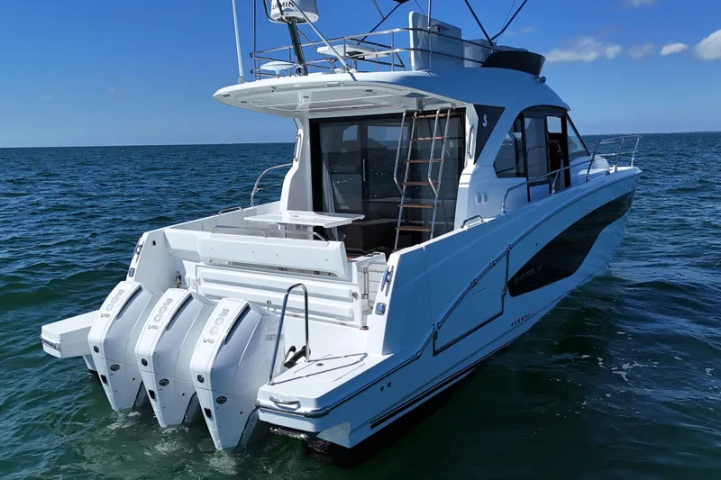  Yacht Photos Pics 2026 Beneteau Antares 12 yacht with triple outboard engines on open water.