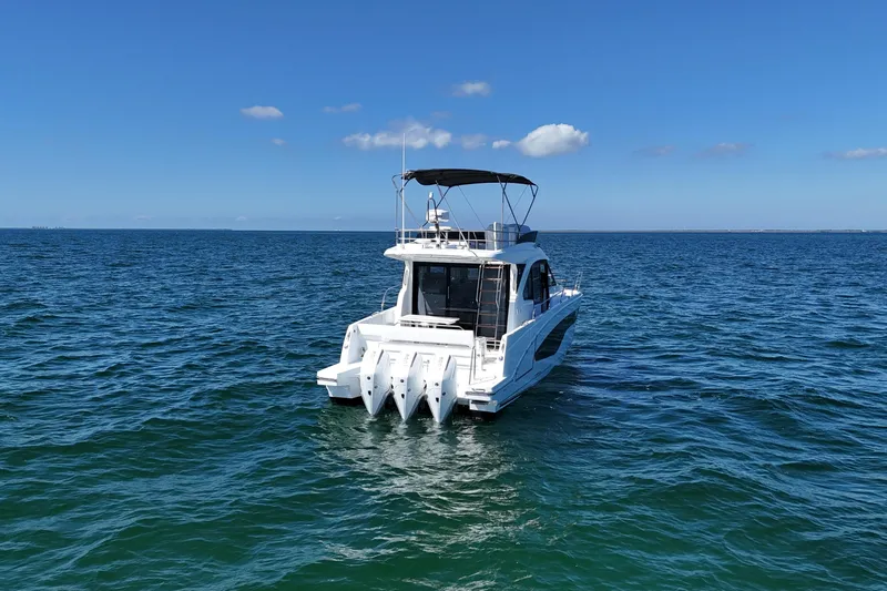  Yacht Photos Pics 2026 Beneteau Antares 12 yacht on open sea under clear blue sky.