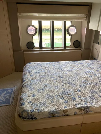 4771 Yacht Photos Pics Luxurious bedroom interior of 2013 Ferretti 720 yacht with elegant bedding and porthole windows.