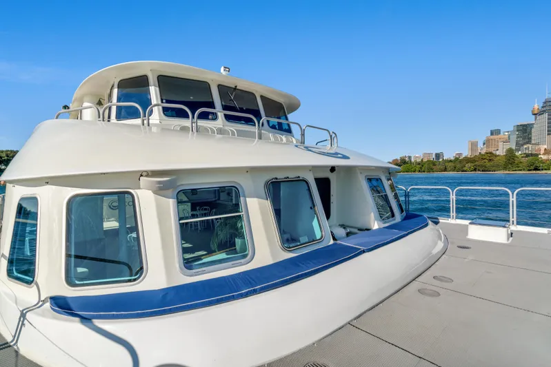 Coast Yacht Photos Pics 2006 Suncoast 65 boat on water with city skyline in background.
