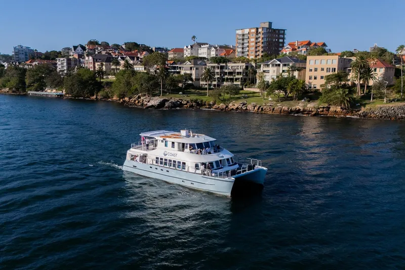 Coast Yacht Photos Pics Suncoast 65 yacht cruising near coastal residential area, 2006 model.