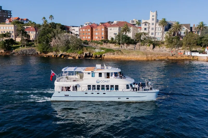 Coast Yacht Photos Pics Suncoast 65 yacht cruising near scenic coastline, 2006 model.