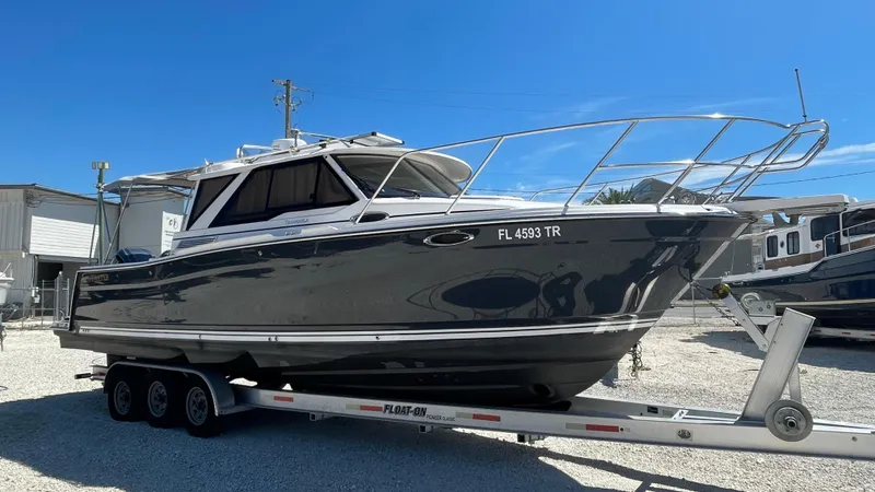  Yacht Photos Pics 2023 Cutwater C-288 boat on trailer under clear blue sky.