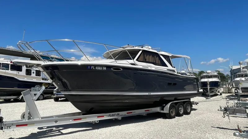  Yacht Photos Pics 2023 Cutwater C-288 boat on trailer under clear blue sky.
