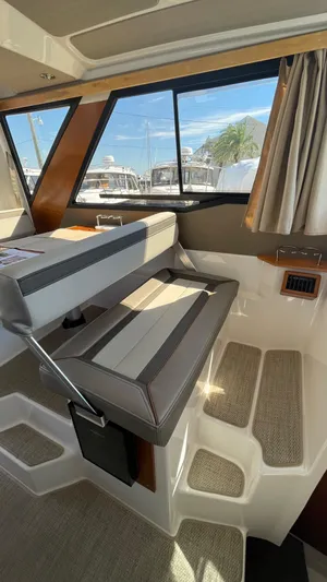  Yacht Photos Pics Interior of 2023 Cutwater C-288 boat with cushioned seating and large windows.