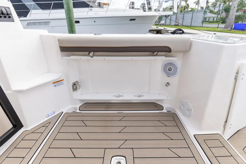  Yacht Photos Pics 2023 Cutwater C-288 boat deck with wood finish and storage compartments.