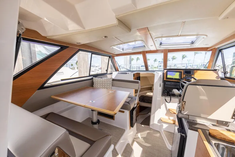  Yacht Photos Pics Interior of 2023 Cutwater C-288 boat, featuring modern seating and navigation area.