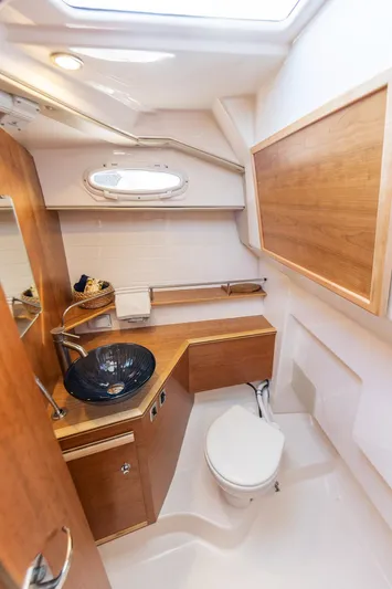  Yacht Photos Pics 2023 Cutwater C-288 boat bathroom with modern fixtures and wood accents.