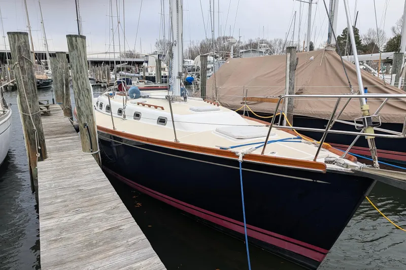 Thistle Yacht Photos Pics Sailboat docked at marina, Tartan 3700 model, 2001, with wooden trim and blue hull.