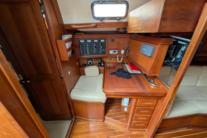 Thistle Yacht Photos Pics Interior of 2001 Tartan 3700 sailboat with navigation station and wooden cabinetry.