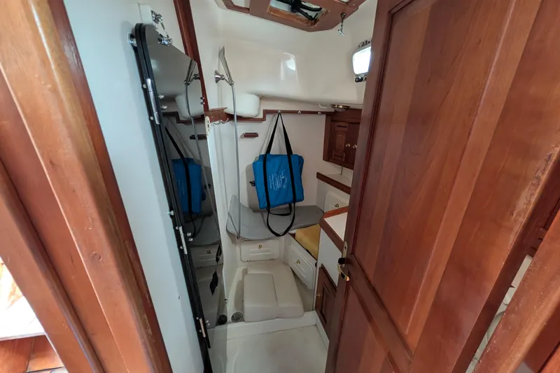Thistle Yacht Photos Pics Interior of 2001 Tartan 3700 sailboat with wooden cabinetry and compact layout.