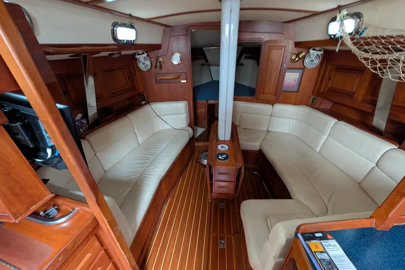 Thistle Yacht Photos Pics Luxurious interior of a 2001 Tartan 3700 sailboat with elegant wood finish.
