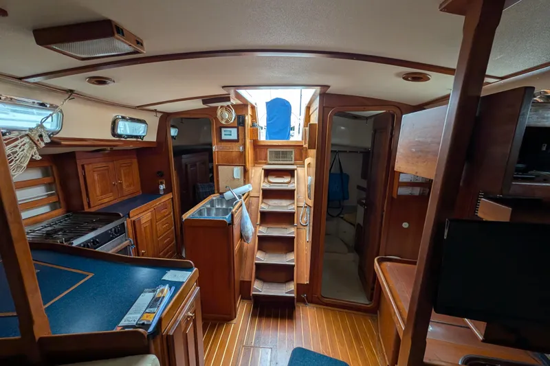 Thistle Yacht Photos Pics Interior of 2001 Tartan 3700 sailboat with wooden cabinetry and modern amenities.