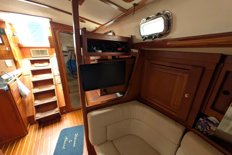 Thistle Yacht Photos Pics Interior of 2001 Tartan 3700 sailboat with wooden cabinetry and seating area.