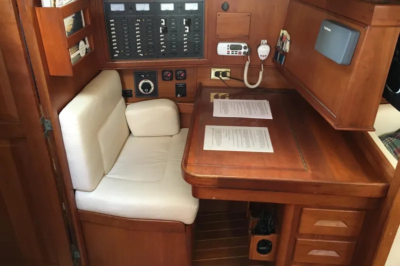 Thistle Yacht Photos Pics Navigation station in 2001 Tartan 3700 sailboat with control panel and seating.