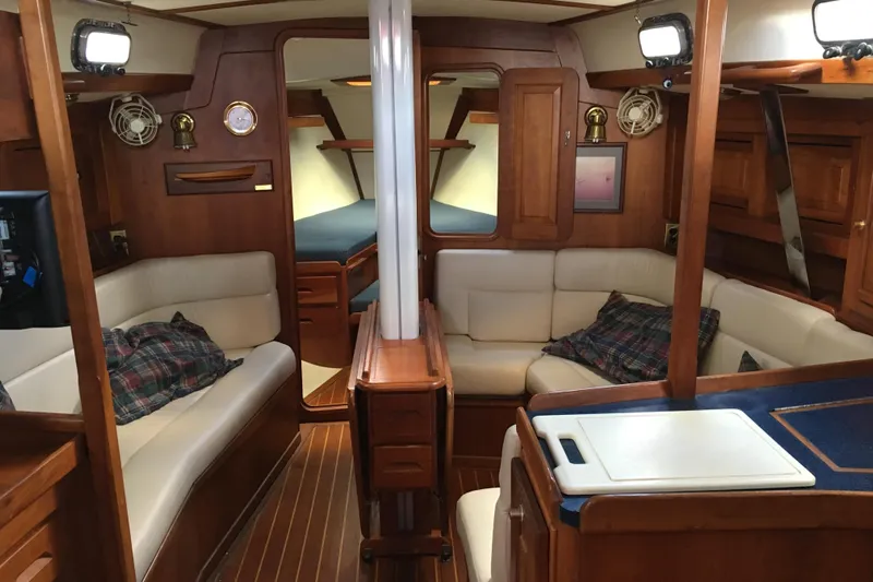 Thistle Yacht Photos Pics Interior of 2001 Tartan 3700 sailboat with cozy seating and wooden finishes.