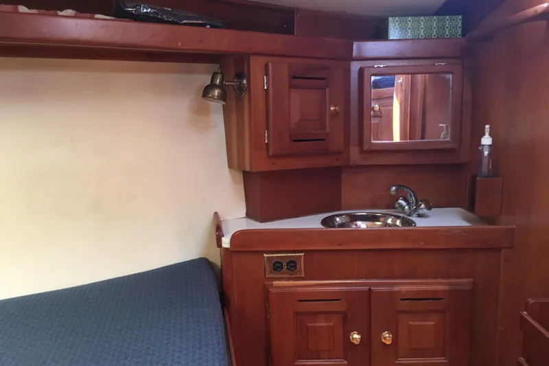 Thistle Yacht Photos Pics Wooden interior of 2001 Tartan 3700 yacht with sink and storage cabinets.