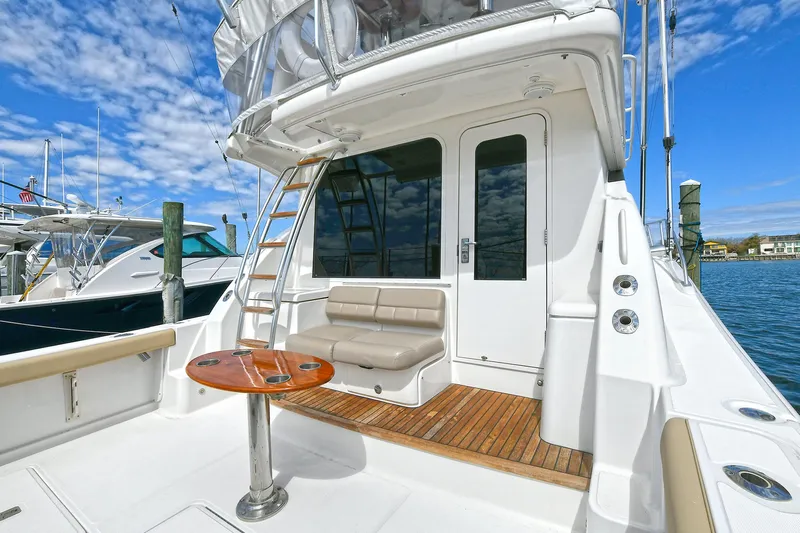 Lady A Yacht Photos Pics 2017 Tiara Yachts 39 Convertible with seating and table on deck, docked by the water.