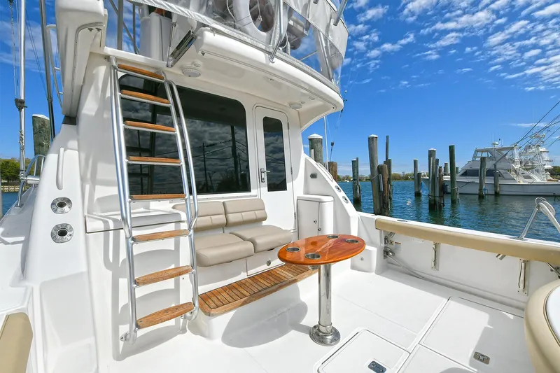 Lady A Yacht Photos Pics 2017 Tiara Yachts 39 Convertible, spacious deck with seating and ladder, docked by the water.