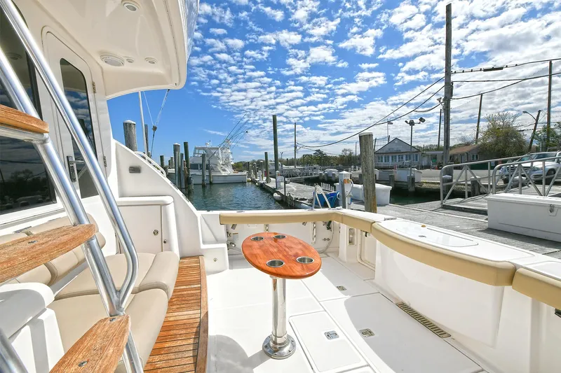 Lady A Yacht Photos Pics 2017 Tiara Yachts 39 Convertible at dock, featuring spacious deck and seating under a blue sky.