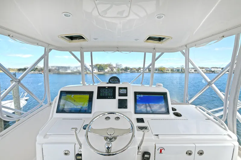 Lady A Yacht Photos Pics Helm of 2017 Tiara Yachts 39 Convertible with dual displays, overlooking serene waters.