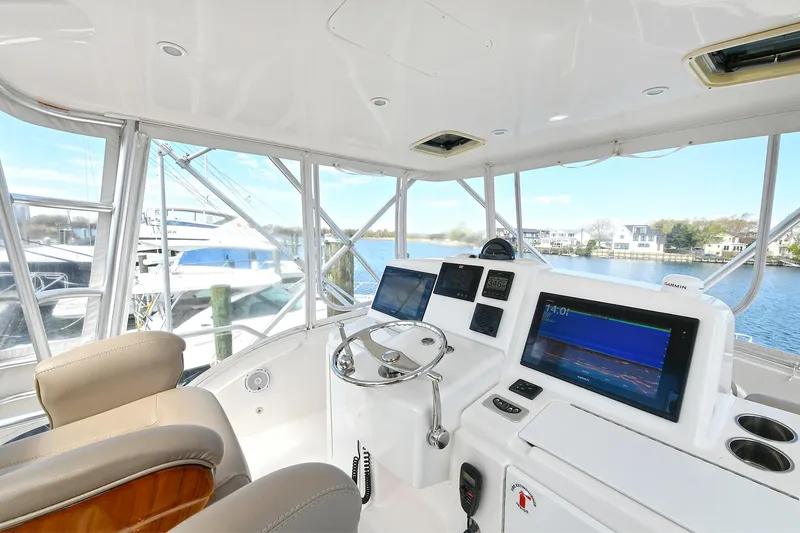 Lady A Yacht Photos Pics Helm of 2017 Tiara Yachts 39 Convertible with modern navigation equipment and waterfront view.