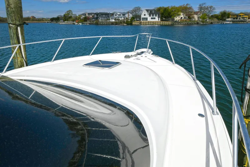 Lady A Yacht Photos Pics 2017 Tiara Yachts 39 Convertible on serene water with scenic shoreline view.