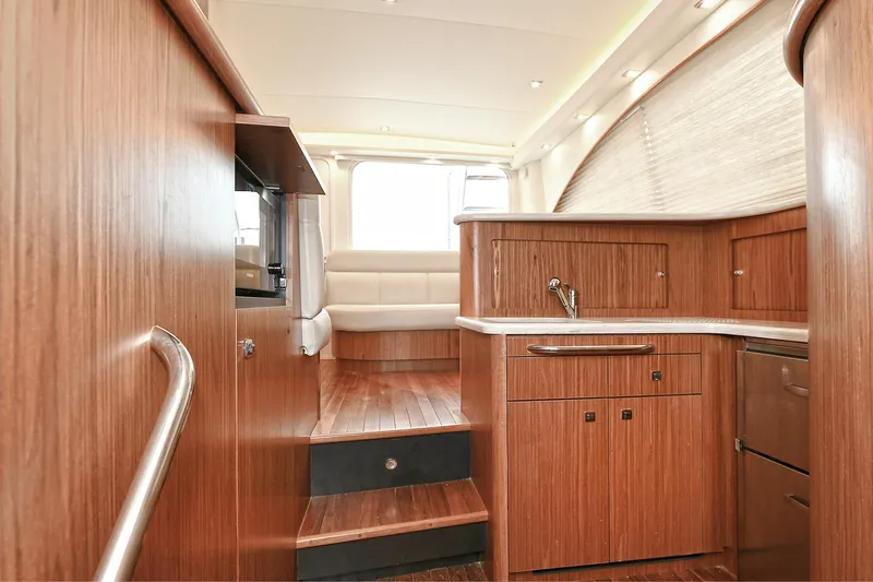 Lady A Yacht Photos Pics Interior of 2017 Tiara Yachts 39 Convertible, featuring wood cabinetry and seating area.