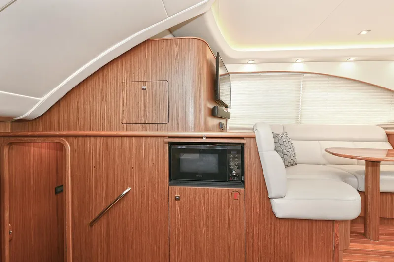 Lady A Yacht Photos Pics Interior of 2017 Tiara Yachts 39 Convertible, featuring wood paneling and a cozy seating area.