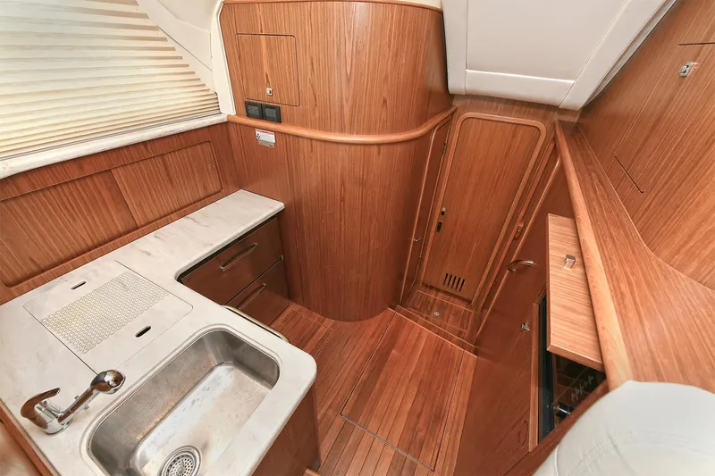 Lady A Yacht Photos Pics 2017 Tiara Yachts 39 Convertible interior with wood finish and compact kitchen area.