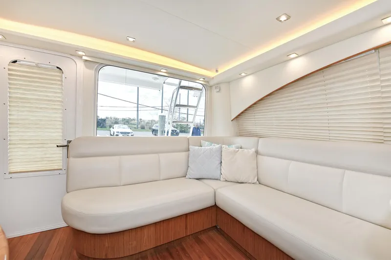 Lady A Yacht Photos Pics Interior of 2017 Tiara Yachts 39 Convertible with elegant white seating and wooden flooring.