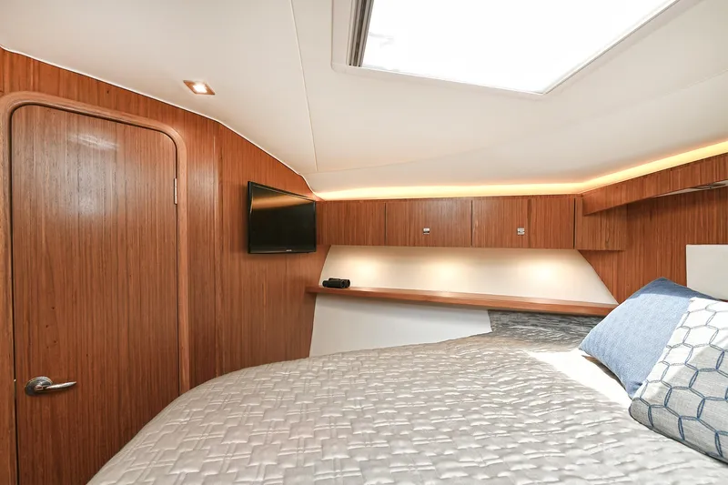Lady A Yacht Photos Pics Interior of 2017 Tiara Yachts 39 Convertible, featuring a cozy bedroom with wood paneling.
