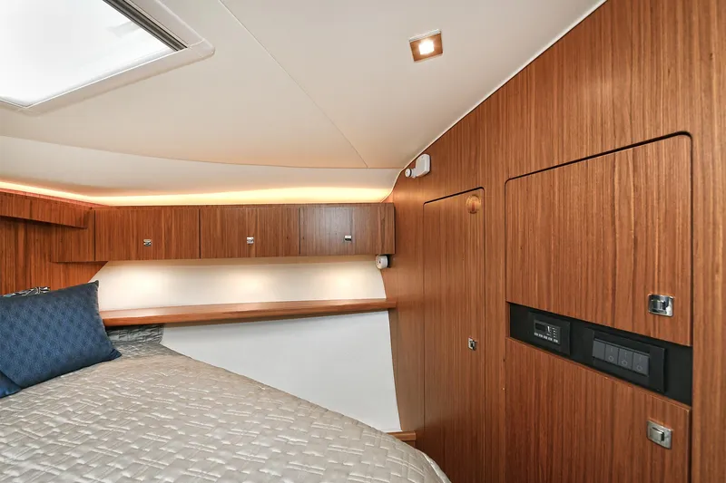Lady A Yacht Photos Pics Interior cabin of 2017 Tiara Yachts 39 Convertible with wood paneling and bedding.
