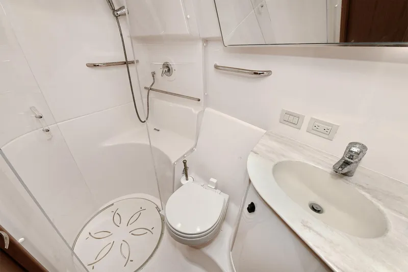 Lady A Yacht Photos Pics Bathroom interior of 2017 Tiara Yachts 39 Convertible, featuring shower, toilet, and sink.