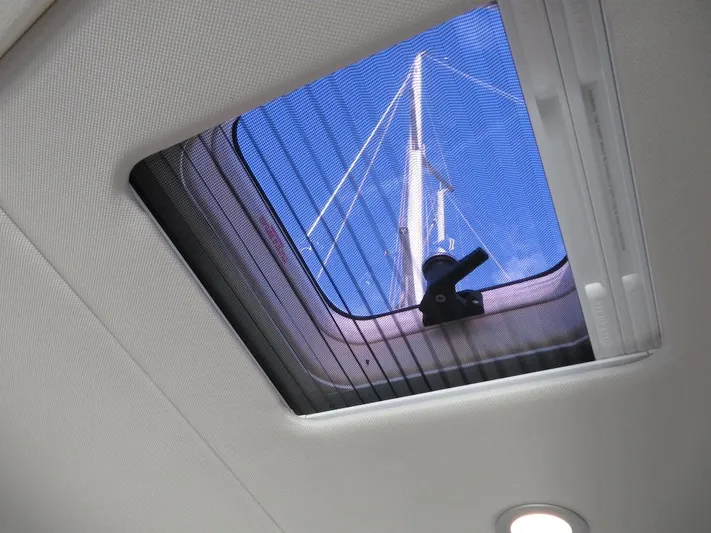  Yacht Photos Pics Skylight view from 2018 Moody 54 DS yacht, showcasing mast against clear blue sky.