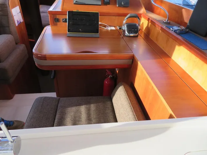  Yacht Photos Pics Interior of 2018 Moody 54 DS yacht with wooden table and seating area.