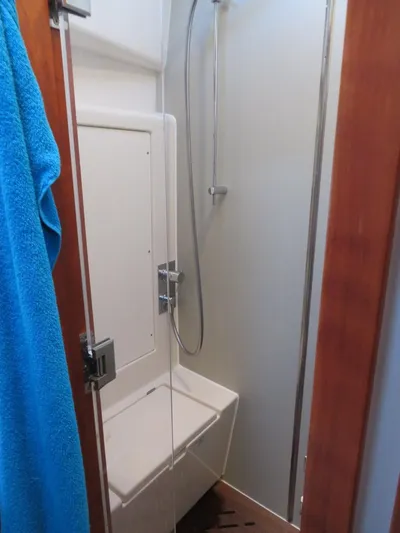  Yacht Photos Pics Compact shower area in 2018 Moody 54 DS yacht with blue towel.