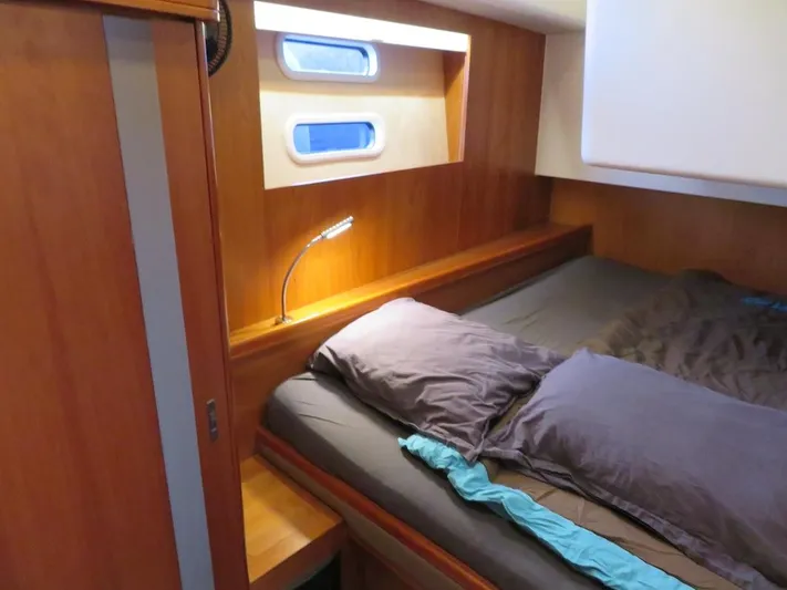  Yacht Photos Pics Cozy cabin interior of 2018 Moody 54 DS yacht with wooden finish and modern lighting.