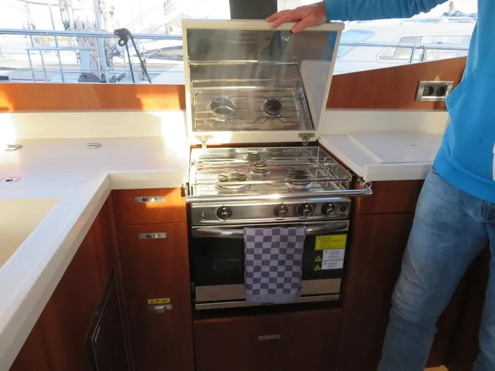  Yacht Photos Pics Modern kitchen area in a 2018 Moody 54 DS yacht with stove and oven.